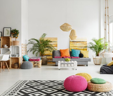 Loft living room with colorful poufs, sofa, carpet, crate furniture